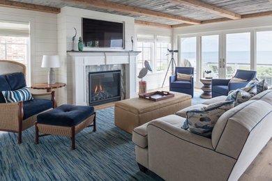 Beach style open concept medium tone wood floor and brown floor living room photo in Bridgeport with white walls, a standard fireplace and a stone fireplace
