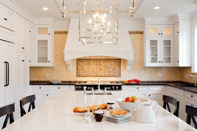 Huge transitional medium tone wood floor eat-in kitchen photo in Vancouver with shaker cabinets, white cabinets, marble countertops, beige backsplash, stainless steel appliances and two islands