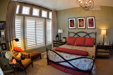 Large master bedroom in Denver with green walls, carpet and beige floor.