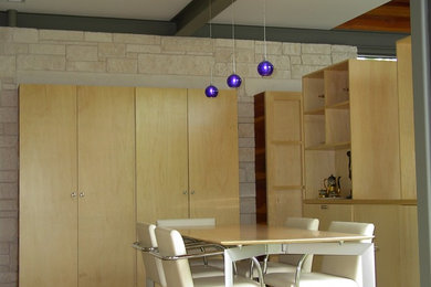 Example of a mid-sized minimalist kitchen/dining room combo design in Austin with beige walls and no fireplace