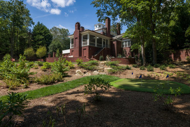 Large transitional stone screened-in back porch idea in Charlotte with a roof extension