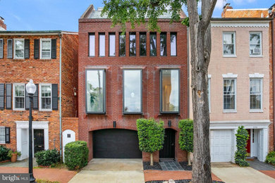 Example of a minimalist red townhouse exterior design in DC Metro