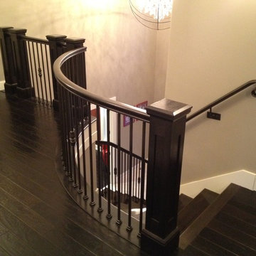 Interior Transitional Staircase with Wrought Iron Balusters