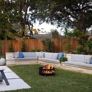 Photo of a transitional backyard partial sun garden in Austin with a fire feature.