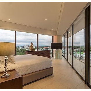 Immagine di una camera matrimoniale etnica di medie dimensioni con pareti beige, pavimento in pietra calcarea e pavimento beige