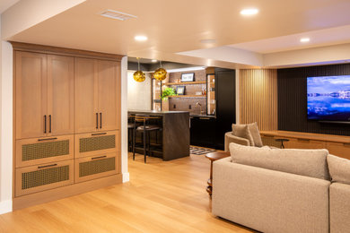 Huge minimalist walk-out vinyl floor, beige floor, coffered ceiling and wallpaper basement photo in Other with a bar, beige walls, a standard fireplace and a tile fireplace