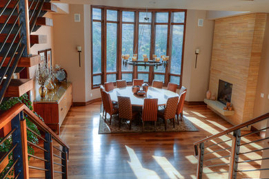 Large trendy light wood floor great room photo in Denver with beige walls, a standard fireplace and a tile fireplace