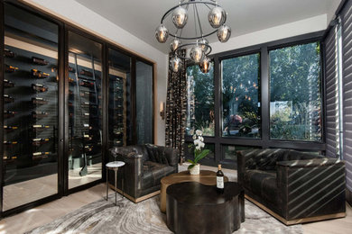 Inspiration for a small contemporary wine cellar in Portland with light hardwood flooring, display racks and beige floors.