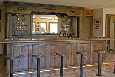 Photo of a large country galley seated home bar in Seattle with raised-panel cabinets, dark wood cabinets and wood benchtops.