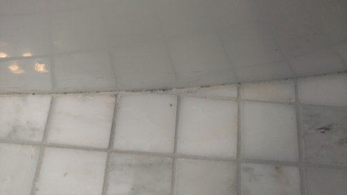 grout next to bathtub