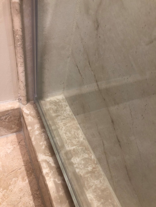 Water pooling between shower bench and door