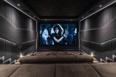 Medium sized contemporary enclosed home cinema in Kent with grey walls, carpet, a projector screen, grey floors and feature lighting.