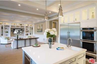 Example of a trendy u-shaped open concept kitchen design in Los Angeles with flat-panel cabinets, white cabinets, marble countertops, white backsplash, subway tile backsplash and an island