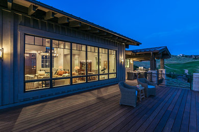 Large transitional backyard second story privacy and metal railing deck photo in Salt Lake City with a roof extension