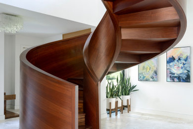 Example of a mid-sized 1950s wooden spiral wood railing staircase design in New Orleans with wooden risers