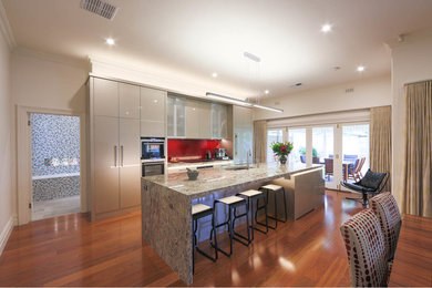 This is an example of a large modern kitchen in Adelaide with medium hardwood floors.