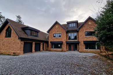 This is an example of an expansive contemporary house exterior in Oxfordshire with three floors.