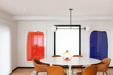 Trendy medium tone wood floor and brown floor enclosed dining room photo in Portland with white walls and no fireplace