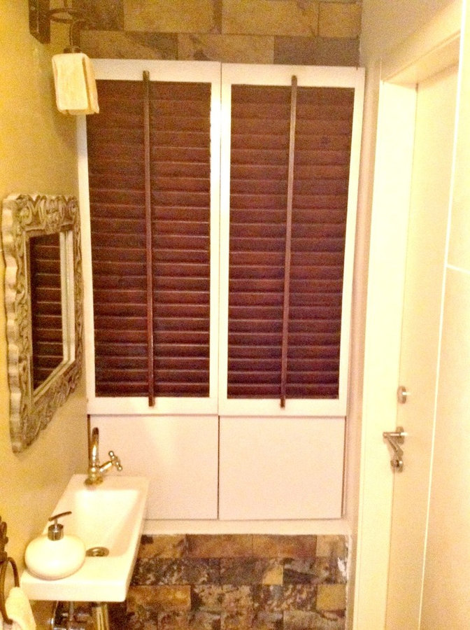 old shutters hide electrical box with slate around them