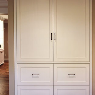 Mid-sized traditional kitchen pantry designs - Example of a mid-sized classic u-shaped medium tone wood floor kitchen pantry design in Cedar Rapids with stainless steel appliances, no island, a double-bowl sink, raised-panel cabinets, white cabinets, granite countertops, beige backsplash and stone slab backsplash