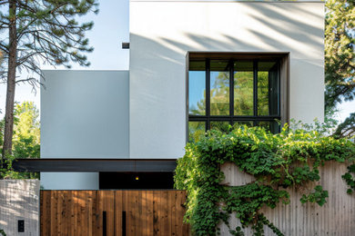 Mid-sized modern white two-story stucco exterior home idea in Phoenix