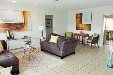This is an example of a mid-sized transitional open concept living room in Miami.