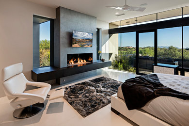 Large modern master bedroom in Phoenix with beige walls, porcelain floors, a ribbon fireplace and a concrete fireplace surround.