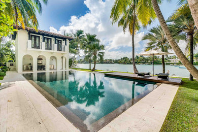 Island style pool photo in Miami