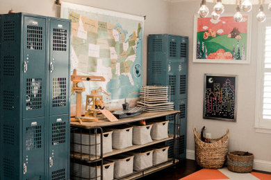 This is an example of a mid-sized country gender-neutral kids' playroom for kids 4-10 years old in Dallas with grey walls, dark hardwood floors and brown floor.
