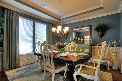 Dining room - contemporary medium tone wood floor dining room idea in Charlotte with blue walls