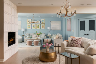 Example of a mid-sized transitional formal and open concept light wood floor, beige floor and wallpaper living room design in Indianapolis with blue walls, a standard fireplace, a tile fireplace and a wall-mounted tv