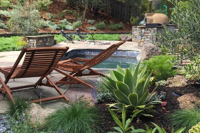 Photo of a rustic hillside landscaping in San Francisco with a fire pit.