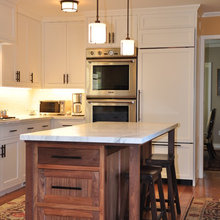 refrigerator next to ovens