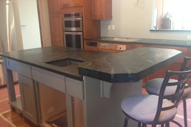 Eat-in kitchen photo in Sacramento with soapstone countertops and two islands