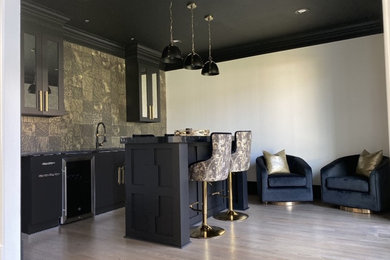 Seated home bar - huge modern single-wall light wood floor and beige floor seated home bar idea in Atlanta with a drop-in sink, recessed-panel cabinets, black cabinets, soapstone countertops, black backsplash, ceramic backsplash and black countertops