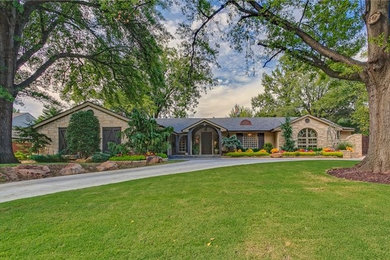 Inspiration for a large transitional beige one-story stone exterior home remodel in Oklahoma City