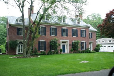 Large traditional brown three-story brick gable roof idea in Bridgeport