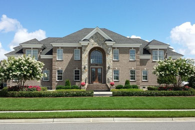 Design ideas for a huge traditional full sun front yard concrete paver landscaping in Other for spring.