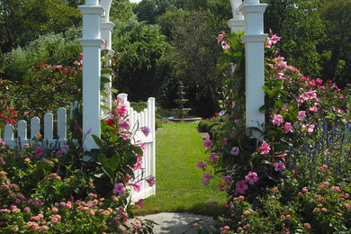 Photo of a mid-sized traditional backyard partial sun formal garden in Other with a water feature.