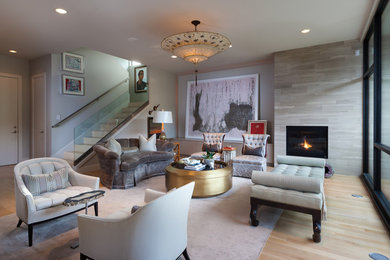 Large trendy formal and open concept light wood floor living room photo in Houston with gray walls, a standard fireplace and a stone fireplace