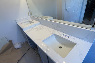 Minimalist master double-sink bathroom photo in Dallas with raised-panel cabinets, gray cabinets, quartz countertops, white countertops and a built-in vanity