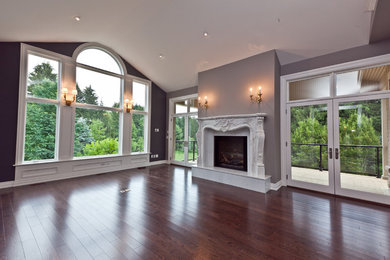 Large transitional formal and open concept medium tone wood floor and brown floor living room photo in Orange County with gray walls, a standard fireplace, a stone fireplace and no tv