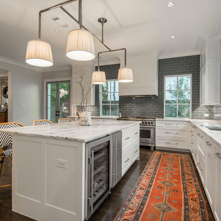 Transitional kitchen pictures - Kitchen - transitional l-shaped dark wood floor kitchen idea in Dallas with an undermount sink, shaker cabinets, white cabinets, marble countertops, gray backsplash, stainless steel appliances and an island