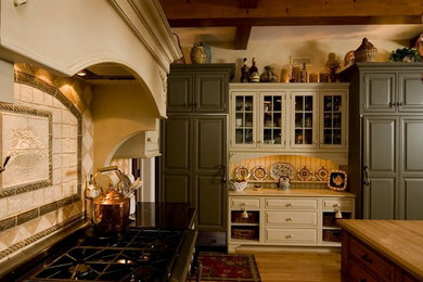 Kitchen - traditional medium tone wood floor kitchen idea in Cleveland with raised-panel cabinets, wood countertops, beige backsplash, ceramic backsplash, paneled appliances and two islands