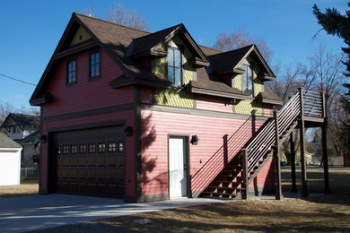 This is an example of a small traditional two-storey red exterior in Other with mixed siding.