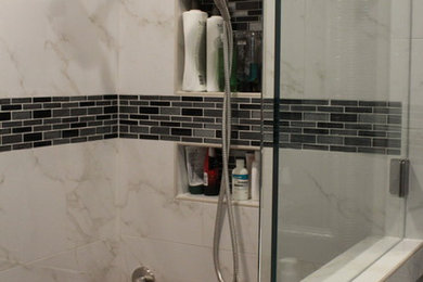 Small transitional master white tile and porcelain tile porcelain tile and gray floor bathroom photo in Houston with shaker cabinets, gray cabinets, gray walls, granite countertops and a hinged shower door