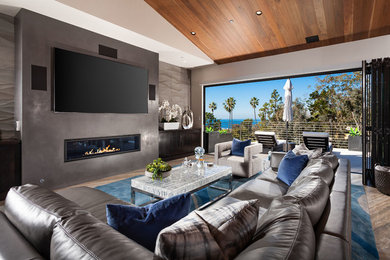 Example of a huge trendy travertine floor living room design in Orange County with a ribbon fireplace