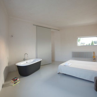 Inspiration for a large contemporary master bedroom in Rome with white walls and porcelain floors.