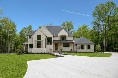 Country beige two-story stucco house exterior idea in Cleveland with a hip roof and a shingle roof