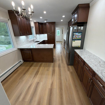 USCD cabinetry accompanied granite countertops, porcelain tile backsplash and Ca